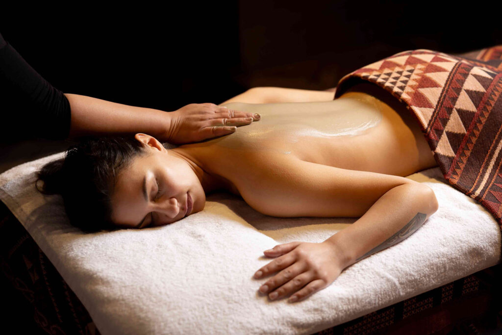 Guests receiving a geothermal mud treatment during a massage at Wai Ariki's Spa Sanctuary.