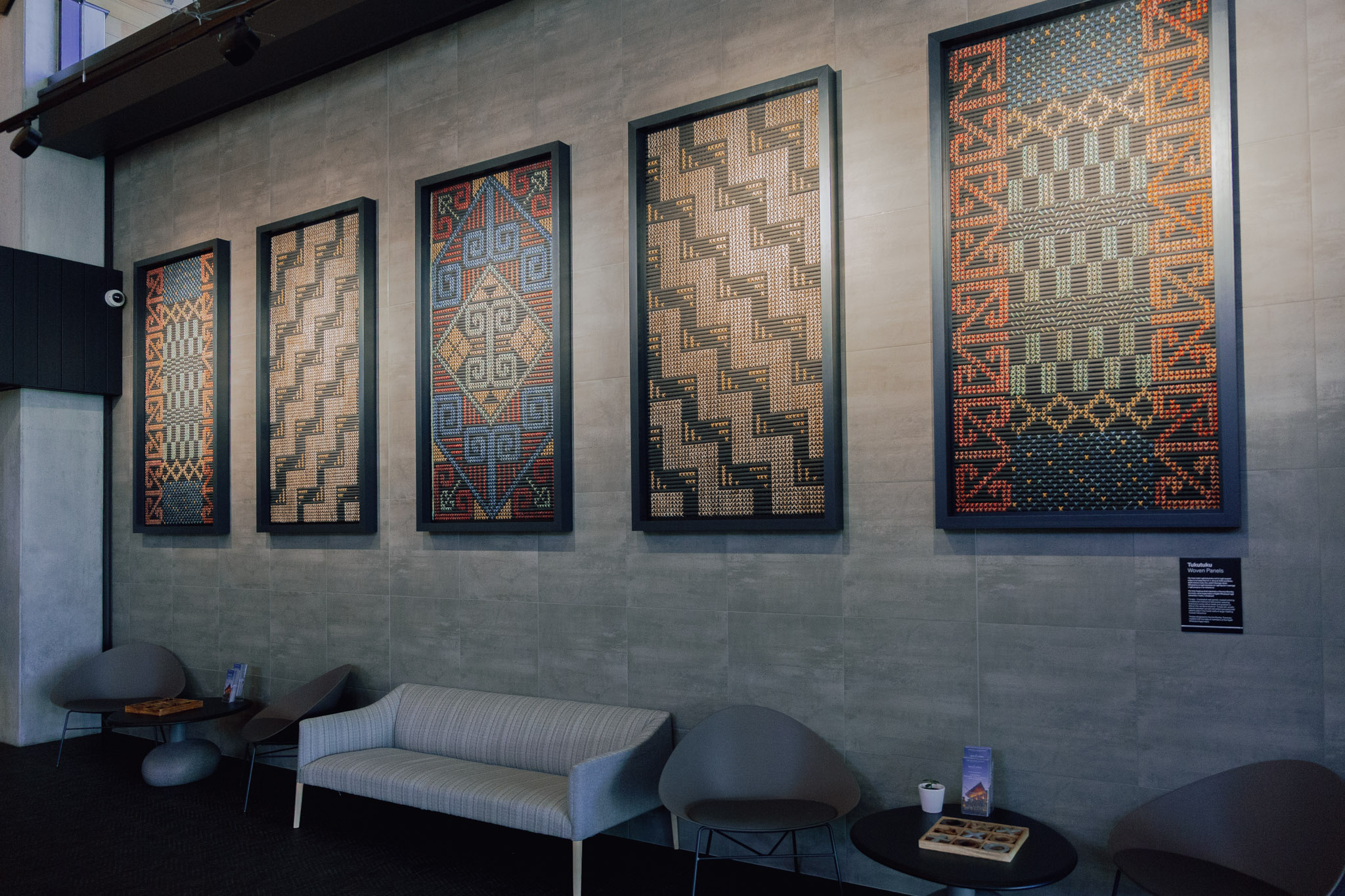Tukutuku woven panels displayed on a wall inside Wai Ariki Hot Springs and Spa, showcasing traditional Māori patterns and craftsmanship.