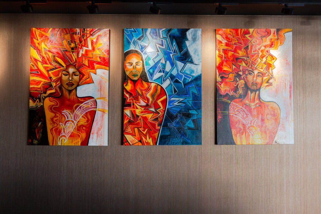 Contemporary artworks depicting figures from Māori cultural narratives, displayed within Wai Ariki Hot Springs and Spa.