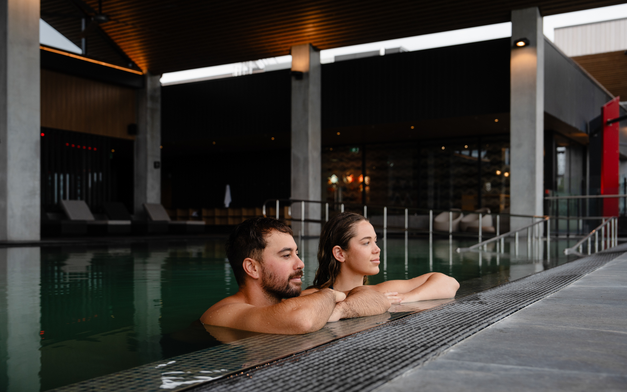 Guests resting beside a geothermal pool during the Wai Whakaora Restorative Journey.