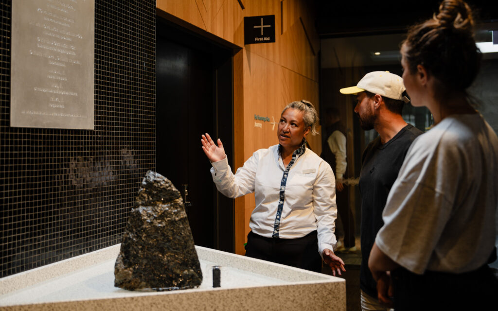 Guide sharing the story of Te Hihiri, the Mauri Blessing Stone, with manuhiri during a cultural experience at Wai Ariki Hot Springs and Spa.